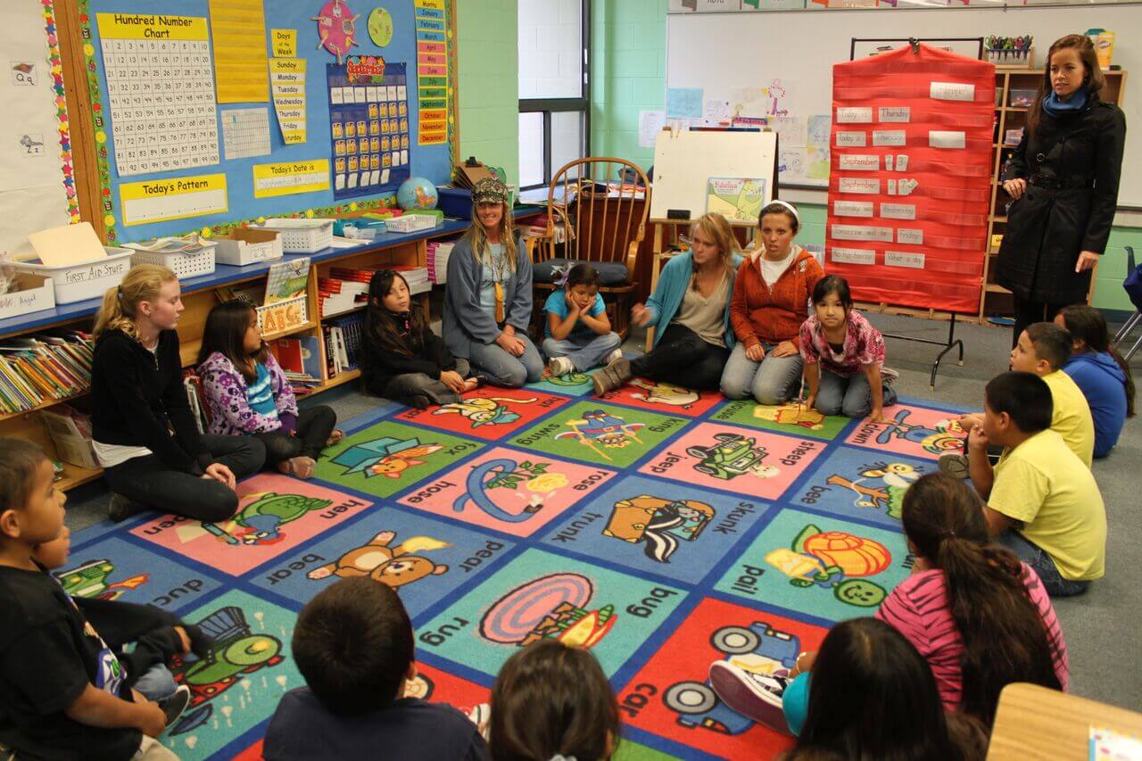 a multigenerational classroom with high school students teaching children