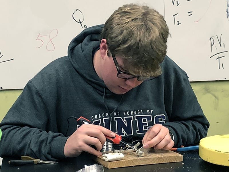 a grauer student soldering a project