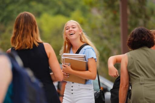 a student greeting her friends