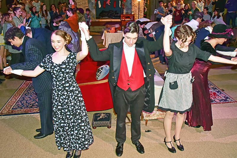 students receiving a standing ovation at the end of a play