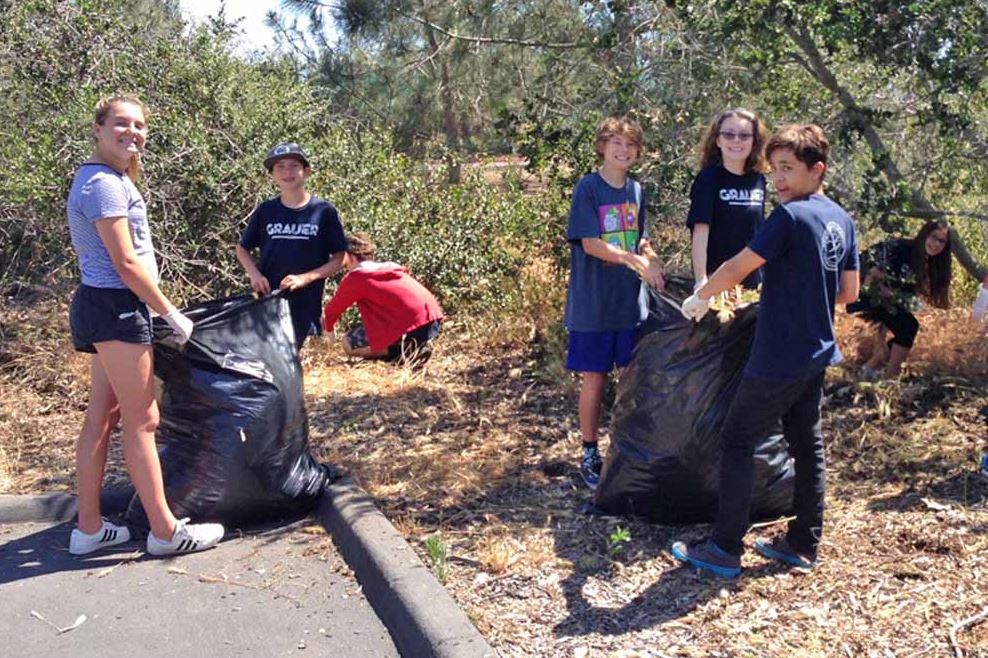 a group of students participating in a community clean up effort