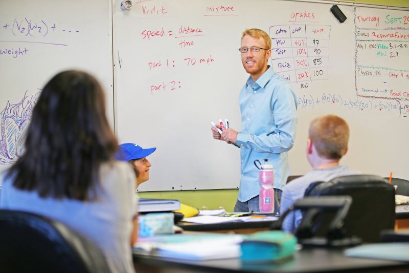 a math teacher guiding his students