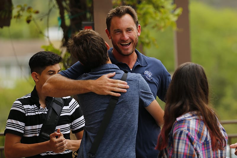 teacher trevor hugs students on the first day of school