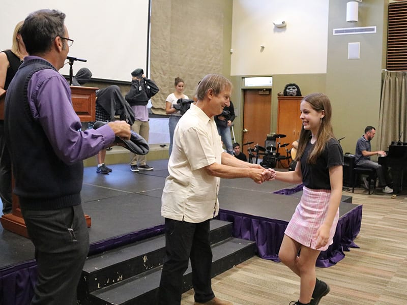 dr. grauer and students in a ceremony