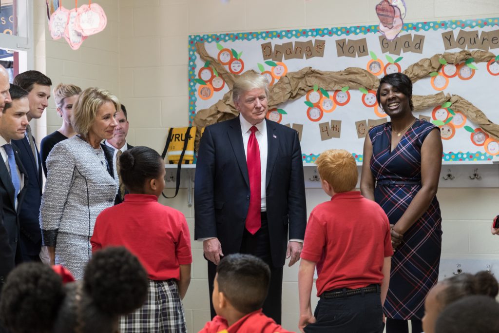 Betsy DeVos and President Trump in a classroom greeting session