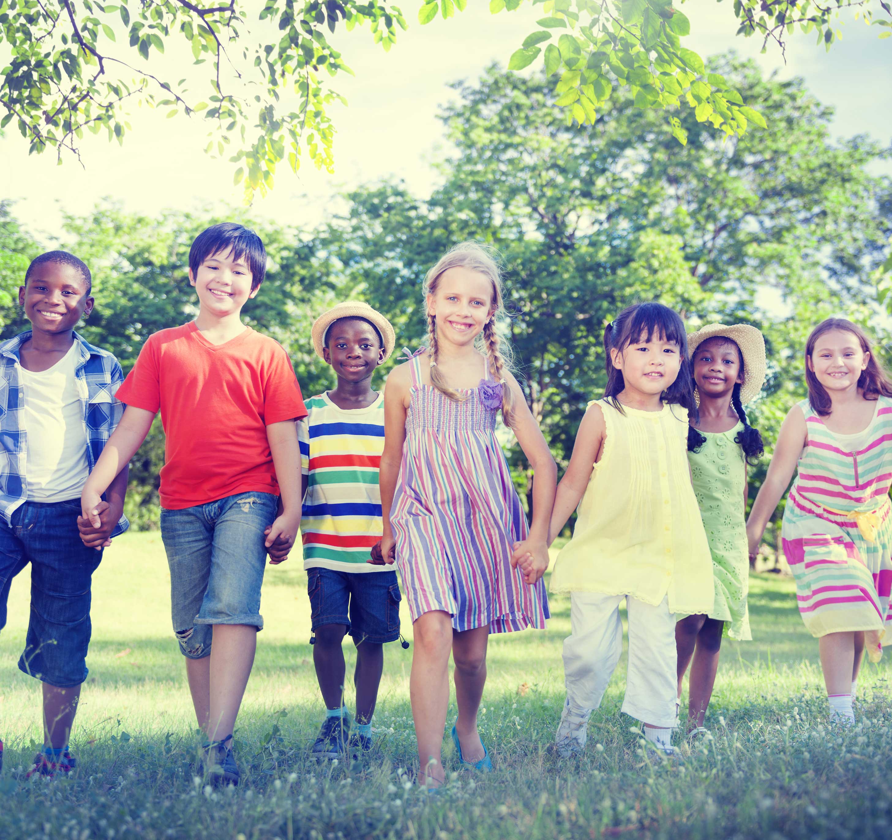 a diverse group of children holding hands together