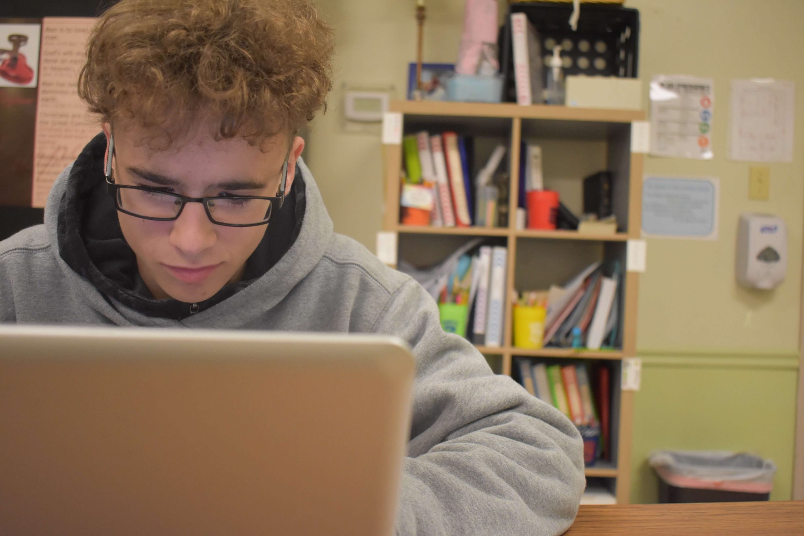 a student working on his computer at Elim Christian School