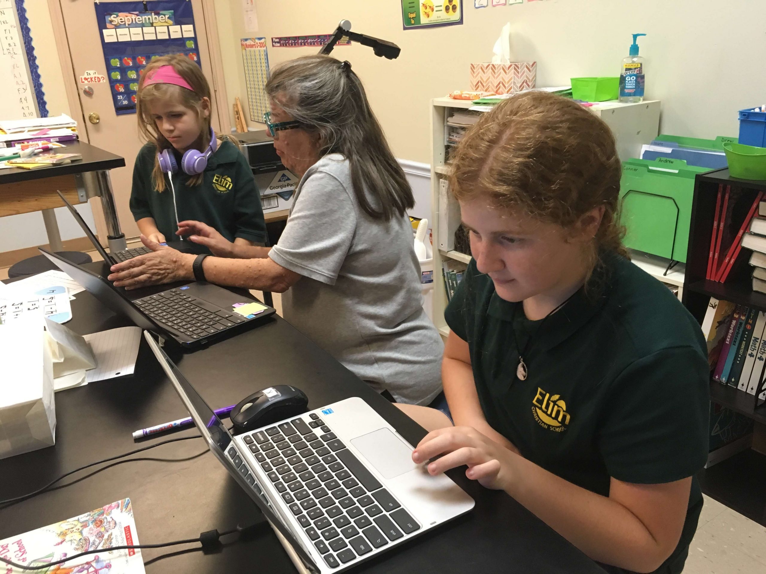 elim christian school students working on laptops