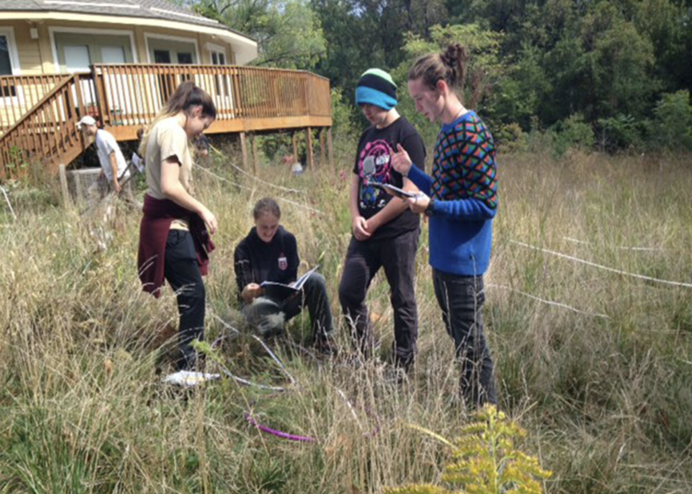 Group of students outside in prairie grass learning