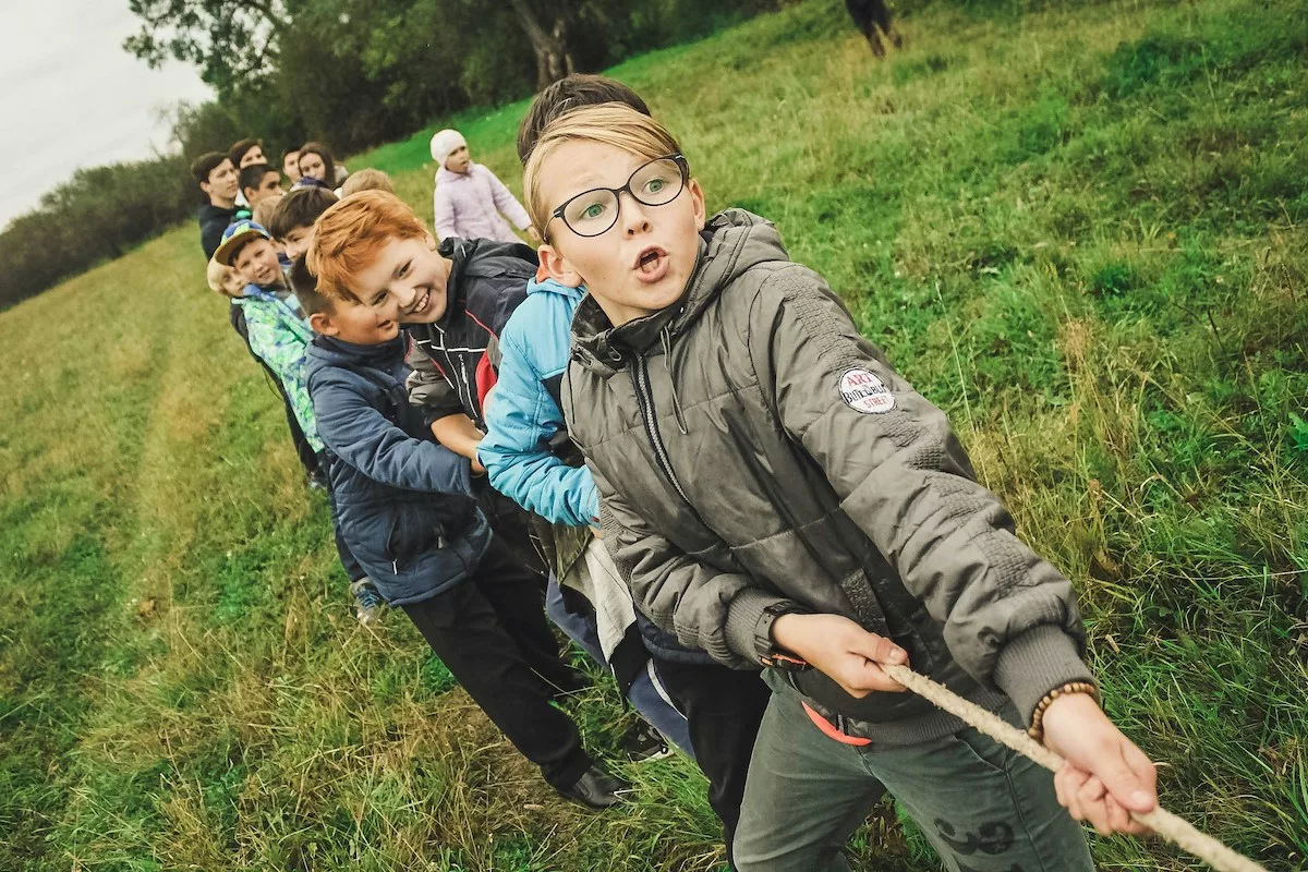 Kids pulling on a rope outside