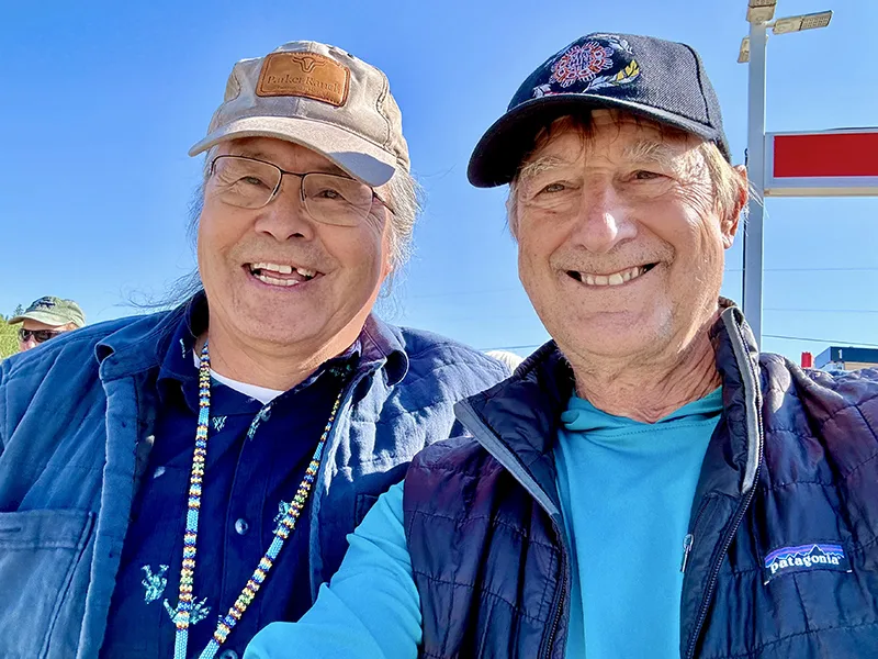 Stuart Grauer smiling with an older man with a blue sky behind them