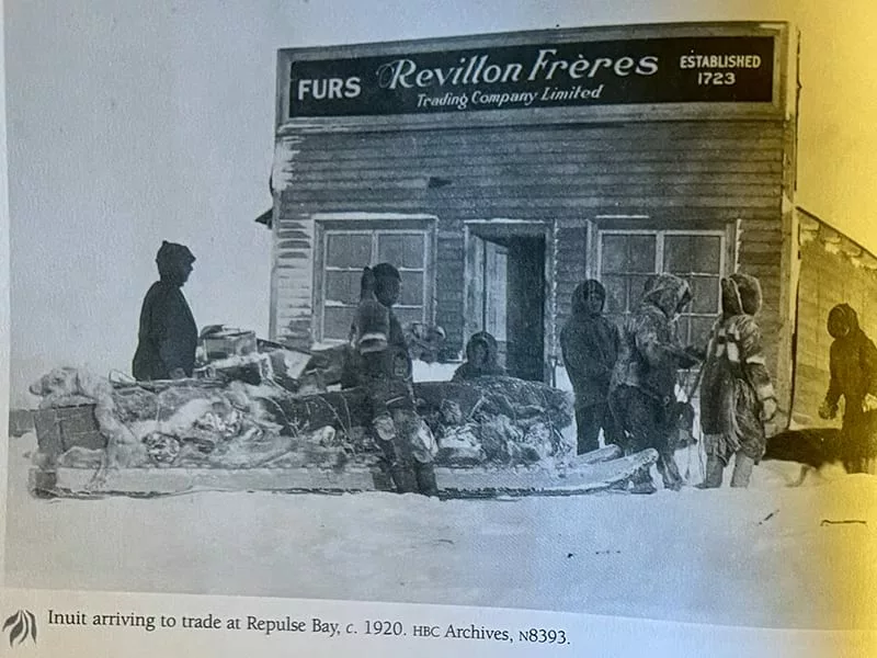 An old newspaper picture showing people arriving at a fur trading building